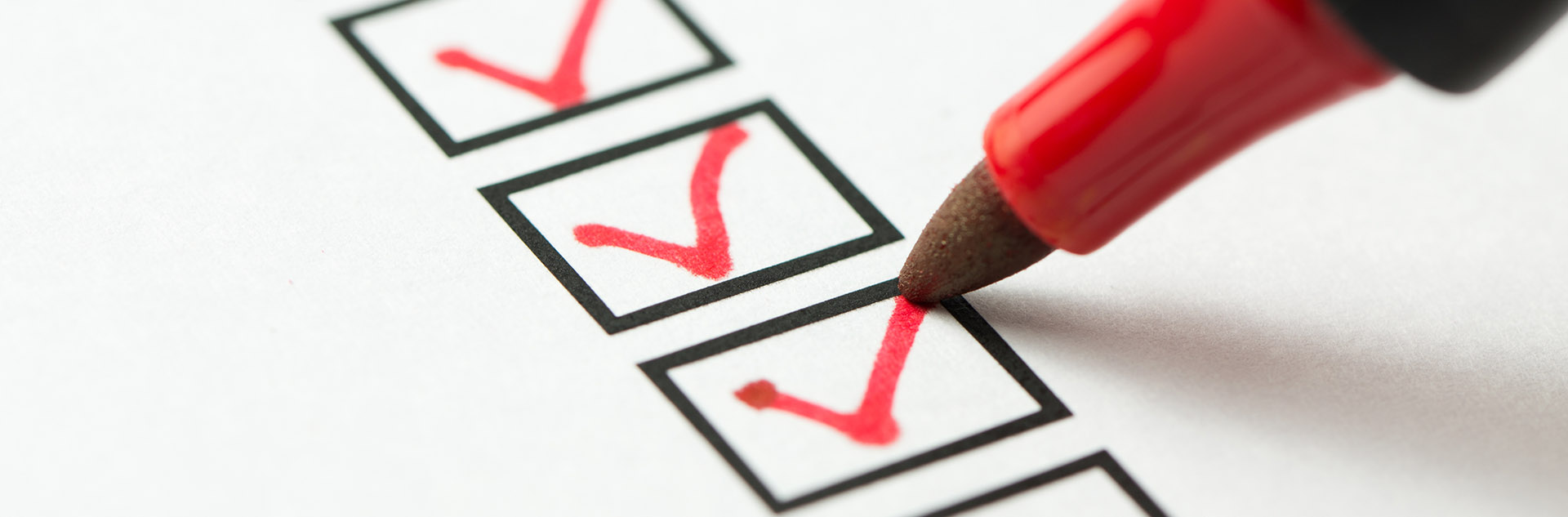 Stock image of a marker checking a box on a checklist.